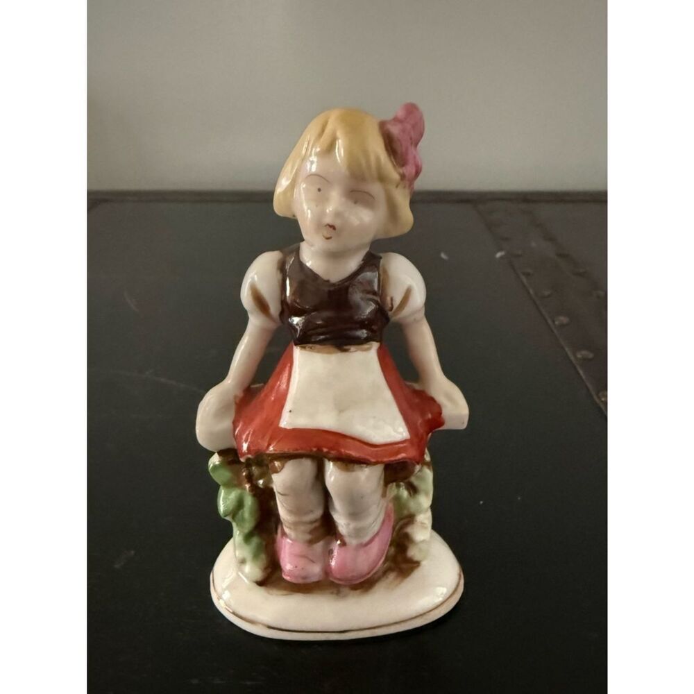 Vintage Small Figurine of Girl Sitting On Wall/Fence Made in Occupied Japan 4”